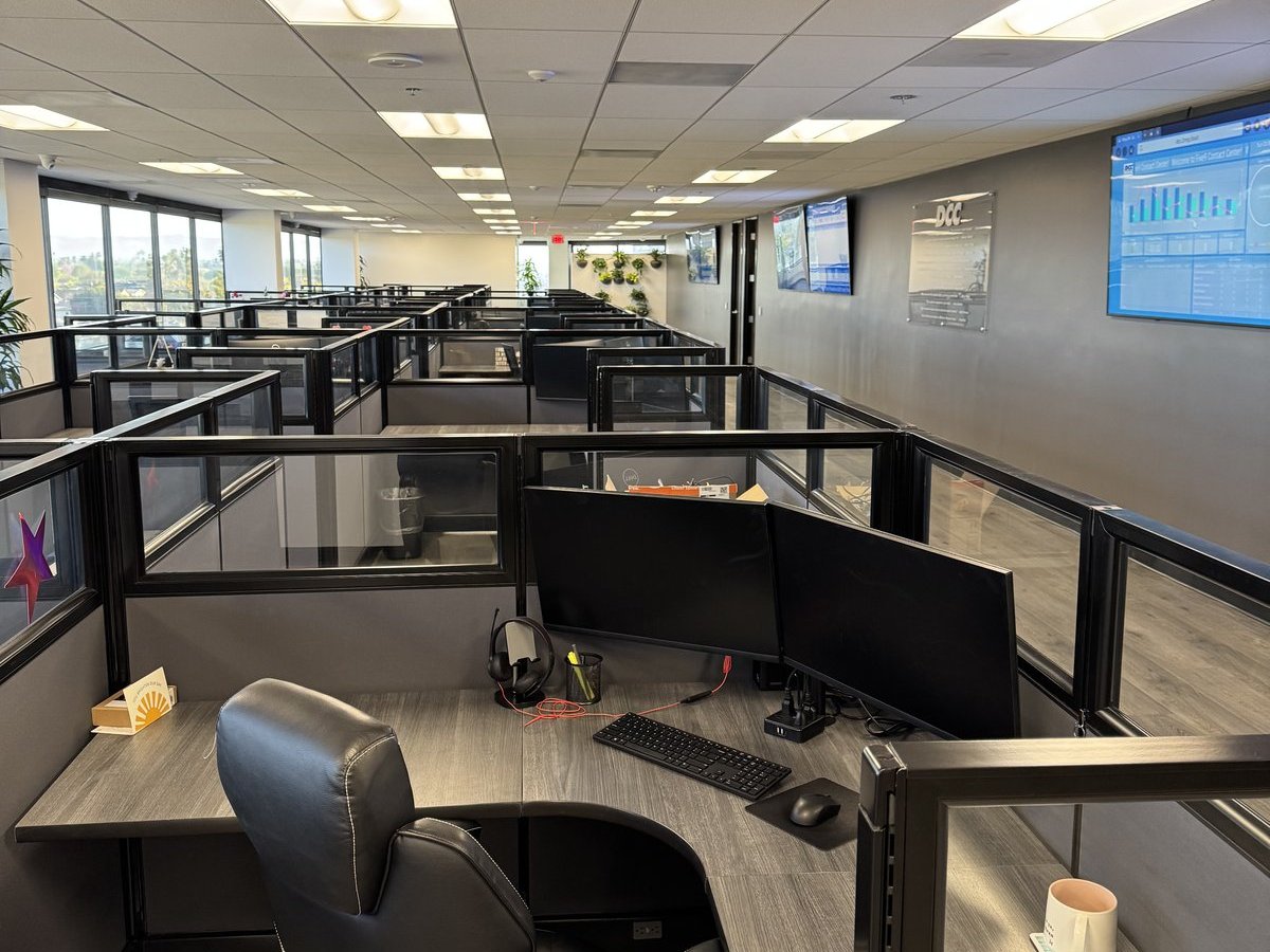 Anaheim call center floor, agents on live calls, natural daylight